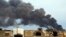 Smoke billows from a factory after an airstrike by forces loyal to former general Khalifa Haftar, in Benghazi, Libya, Oct. 22, 2014.