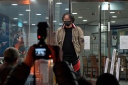 Mike Lam King-nam, who participated in the pro-democracy primary elections, walks out at a police station after being bailed out in Hong Kong, Jan. 7, 2021.