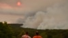 Residents watch a large bushfire as seen from Bargo, southwest of Sydney, on Dec. 19, 2019.