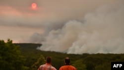 Residents watch a large bushfire as seen from Bargo, southwest of Sydney, on Dec. 19, 2019.