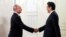 Russian President Vladimir Putin, left, and Japanese Prime Minister Shinzo Abe shake hands before an opening ceremony of the cross-cultural year of Russia and Japan at the Bolshoi Theater in Moscow, Russia, May 26, 2018. 