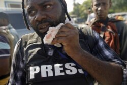Photojournalist Dieu Nalio Chery holds a healing gauze next to his mouth in Port-au-Prince, Haiti, September 23, 2019.