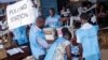 Election officials count ballot papers cast at a polling station in Freetown, Sierra Leone, March 7, 2018.