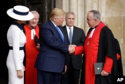FILE - President Donald Trump and First Lady Melania Trump accompanied by John Hall, the Dean of Westminster, right, and Britain's Prince Andrew leave after a tour of Westminster Abbey in London, June 3, 2019.