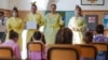 Medical personnel talk to children as they prepare them to receive non-invasive Covid 19 tests with chewing gum at the G.B. Grassi school, in Fiumicino, near Rome, Oct. 6, 2020.