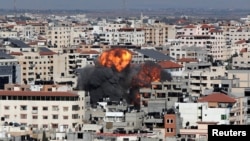 Smoke and flames rise during an Israeli airstrike, amid a flare-up of Israeli-Palestinian violence, in Gaza City, May 14, 2021. 