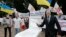 FILE - Anti-corruption activists hold a rally outside parliament in Kyiv, Ukraine, June 15, 2015. The rally organizers put a toilet seat on display as a symbol of what they feel is the effort by top officials to flush away politically inconvenient corruption cases.