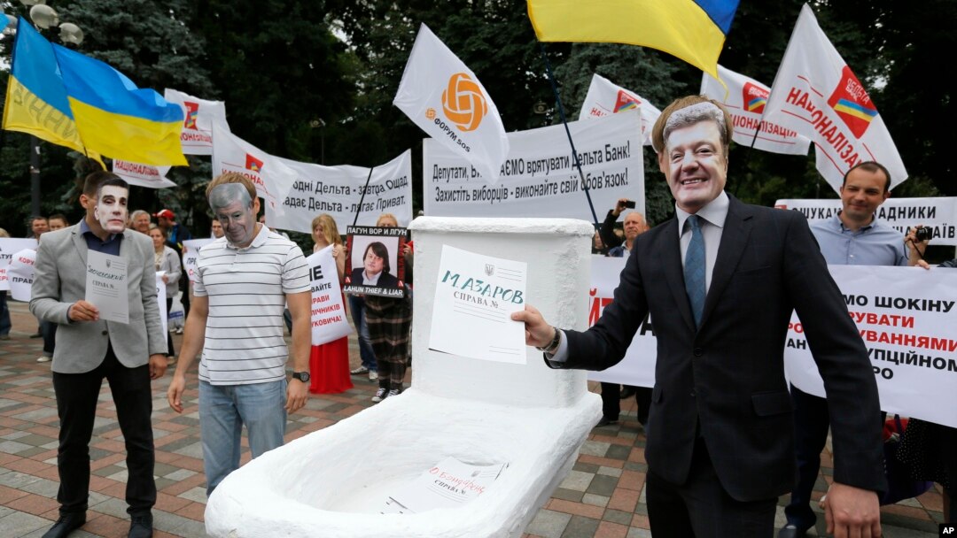 FILE - Anti-corruption activists, wearing masks of government officials, hold a rally outside parliament in Kyiv, Ukraine, June 15, 2015.