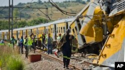 Emergency workers in attendance at the scene of a collision between two passenger trains near Pretoria, South Africa, January 31, 2013.