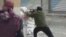 A rebel fires a weapon around a corner at Syrian government forces in Damascus, Syria, December 7, 2012.