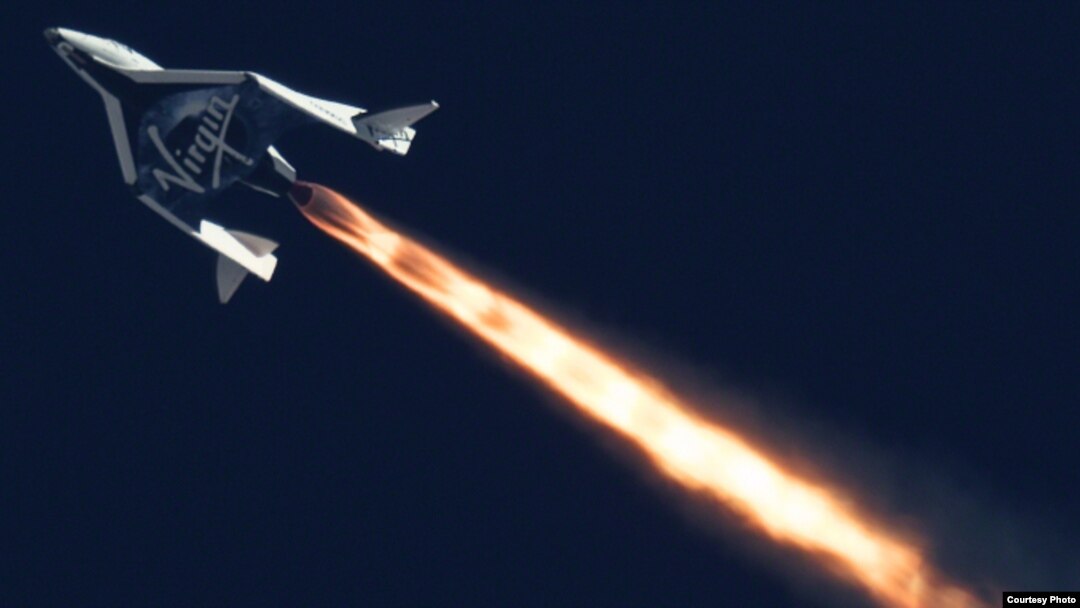 FILE - Virgin Galactic's SpaceShipTwo is seen flying over the Mojave Desert in California in September 2014.