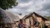 FILE - People displaced by conflict sit in a camp in Komanda, Ituri province, eastern Democratic Republic of Congo, August 30, 2023.