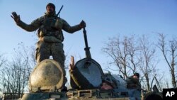 Ukrainian soldiers stand atop an armored personnel carrier near Urzuf on the south coast of Azov sea, eastern Ukraine, Nov. 29, 2018.