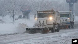 City snow plows clear 23rd Street in Lawrence, Kansas, Feb. 26, 2013. 