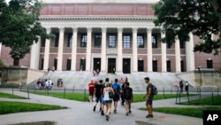 FILE - Students walk near the Widener Library at Harvard University in Cambridge, Massachusetts, Aug. 13, 2019. 