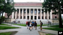 FILE - Students walk near the Widener Library at Harvard University in Cambridge, Massachusetts, Aug. 13, 2019. University and federal officials confirmed that incoming Harvard student Ismail Ajjawi, 17, of Lebanon, was refused entry into the U.S.