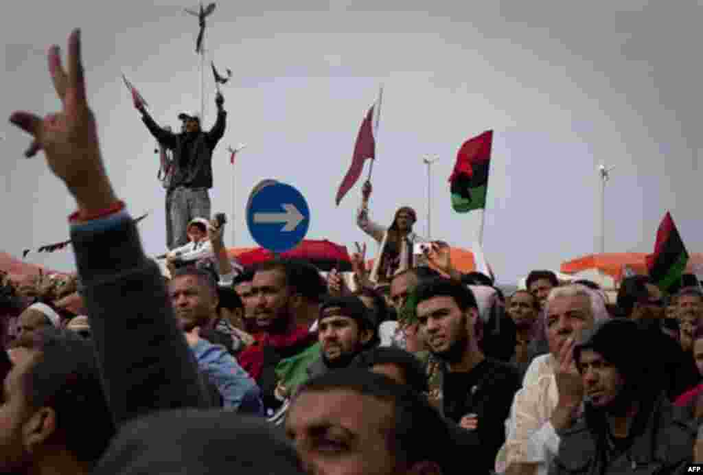 Libyan people celebrate in the main square of Benghazi, eastern Libya, Friday, March 18, 2011. Libya declared an immediate cease-fire Friday, trying to fend off international military intervention after the U.N. authorized a no-fly zone and "all necessary