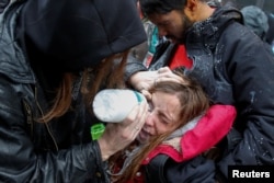 Una mujer es atendida luego de ser afectada por gas pimienta durante las protestas anti-Trump en Washington.