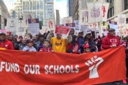 Hundreds of teachers and supporters march, days before the teachers union was set to go on strike if a contract settlement was not reached, in Chicago, Oct. 14, 2019.