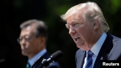 U.S. President Donald Trump (R) and South Korean President Moon Jae-in deliver a joint statement from the Rose Garden of the White House in Washington, June 30, 2017. 