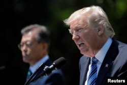 U.S. President Donald Trump (R) and South Korean President Moon Jae-in deliver a joint statement from the Rose Garden of the White House in Washington, June 30, 2017.