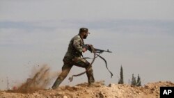 FILE - Shiite fighter clashes with members of the Sunni-dominated Free Syrian Army rebel in the town of Hatita, in the countryside of Damascus, Syria. 