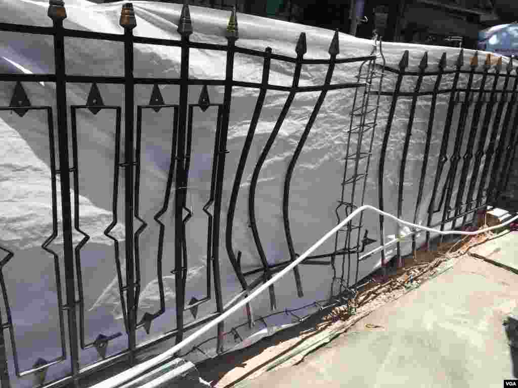 The fence near the Erawan shrine, blasted outward by the bomb explosion. (Steve Herman/VOA News)