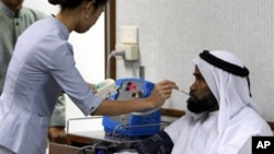 A Thai nurse takes temperature and blood pressure of a patient from Middle East prior to seeing a doctor at Thailand's top private hospital, Bumrungrad International, in Bangkok, 06 September 2006.