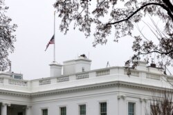 The American flag atop the White House in Washington is lowered to half-staff in honor of those killed in a string of attacks at day spas in and around Atlanta, Georgia, in Washington, March 18, 2021.