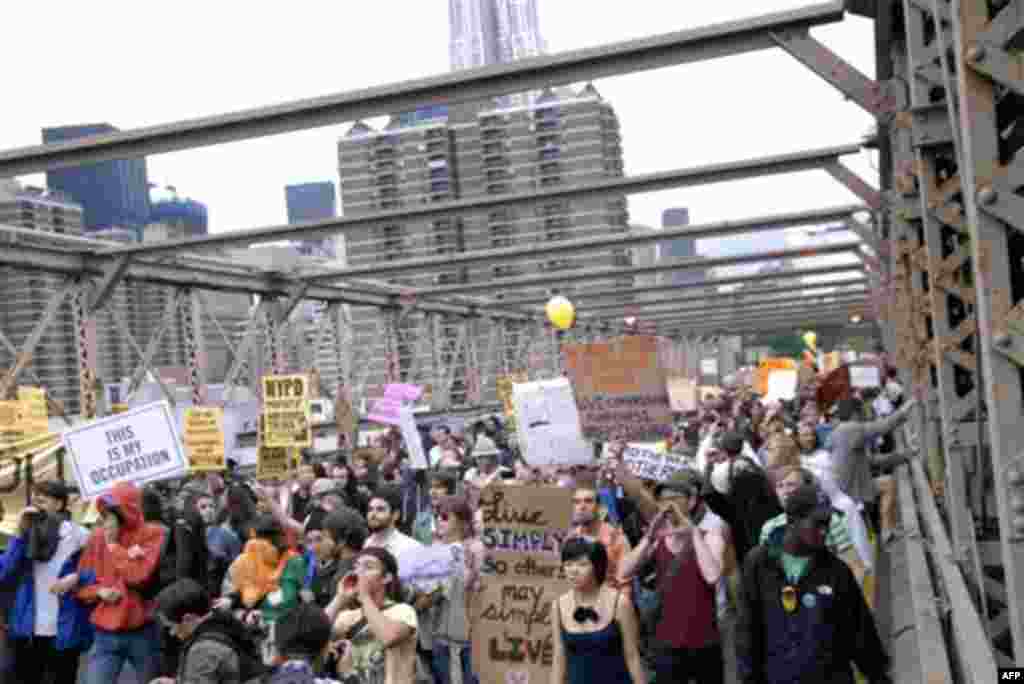 In this Oct. 1, 2011 photo, protesters walk onto New York's Brooklyn Bridge before police began making arrests during Saturday's march by Occupy Wall Street. Protesters speaking out against corporate greed and other grievances attempted to walk over the b