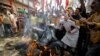 Hindu nationalist Shiv Sena activists burn a scooter during a nationwide strike to protest a steep hike in gas prices in Jammu, India, May 31, 2012. 