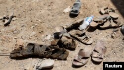 FILE - The shoes of men who were dug up from a mass grave are seen outside the town of Sulaiman Pek in northern Iraq September 5, 2014. Many such graves are appearing in Iraq. 