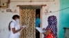 Health workers collect personal data from a man during a door-to-door survey for the first shot of COVID-19 vaccine for people over 50 years of age and those with comorbidities, in a village near Ahmedabad, India, Dec. 14, 2020.