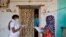 Health workers collect personal data from a man during a door-to-door survey for the first shot of COVID-19 vaccine for people over 50 years of age and those with comorbidities, in a village near Ahmedabad, India, Dec. 14, 2020.
