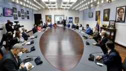 FILE - This handout picture released by the Venezuelan Presidency showing Venezuelan President Nicolas Maduro, 4th from right, speaking during a meeting with members of his cabinet, at the Miraflores Presidential Palace in Caracas, August 20, 2021.