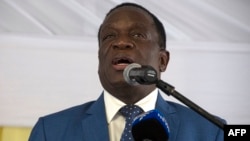 Zimbabwean President Emmerson Mnangagwa delivers a speech during a rally with Zimbabwean businessmen and foreign investors at the Zimbabwean embassy in Pretoria, South Africa, on December 21, 2017. Emmerson Mnangagwa visits South Africa on his first forei