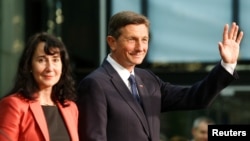 President Borut Pahor and his wife, Tanja Pecar, react after first results of the second round of the presidential elections in Ljubljana, Slovenia, Nov. 12, 2017.