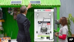 FILE - President Barack Obama looks at a solar power exhibit during a tour of the Power Africa Innovation Fair in Nairobi, Kenya, July 25, 2015. In Nigeria, Lumos Global is among the firms rolling out solar power technology. The company received financing from the U.S. government's Overseas Private Investment Corporation as part of Obama's Power Africa initiative.