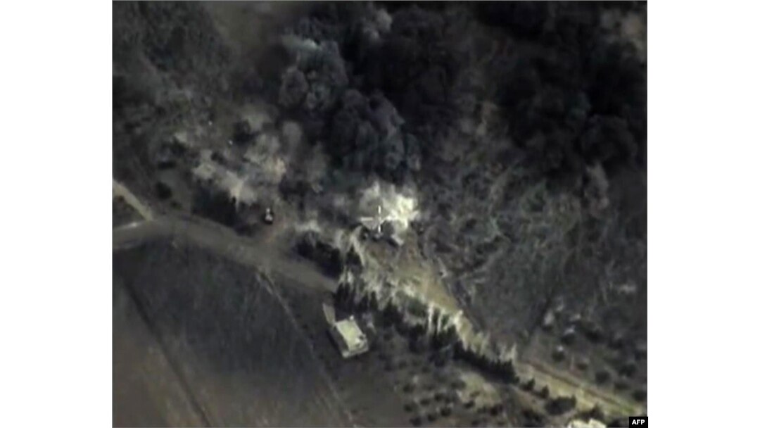 A video grab from Sept. 30, 2015, shows an image taken from footage made available on the Russian Defense Ministry's official website, purporting to show an airstrike in Syria.