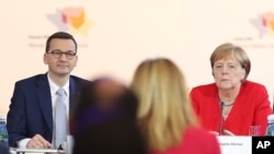 German Chancellor Angela Merkel and Poland's Prime Minister Mateusz Morawiecki listen to a speech by Poland's President Andrzej Duda during a summit on Western Balkan states' EU aspirations, in Poznan, Poland, July 5, 2019.