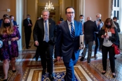 Treasury Secretary Steven Mnuchin, accompanied by White House chief of staff Mark Meadows, leave a meeting with Senate Majority Leader Mitch McConnell as negotiations continue on a coronavirus relief package on Capitol Hill, Aug. 4, 2020.