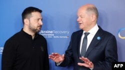 FILE - German Chancellor Olaf Scholz (R) greets Ukrainian President Volodymyr Zelensky as he arrives to attend the Ukraine Recovery Conference in Berlin on June 11, 2024.