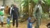 Police officers lead away children after the search of a suspect's home in Kiossi, Cameroon, March 3, 2018. (M. Kindzeka/VOA)