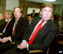Billionaire developer Donald Trump, right, waits with his brother Robert for the start of a Casino Control Commission meeting in Atlantic City, N.J., March 29, 1990.