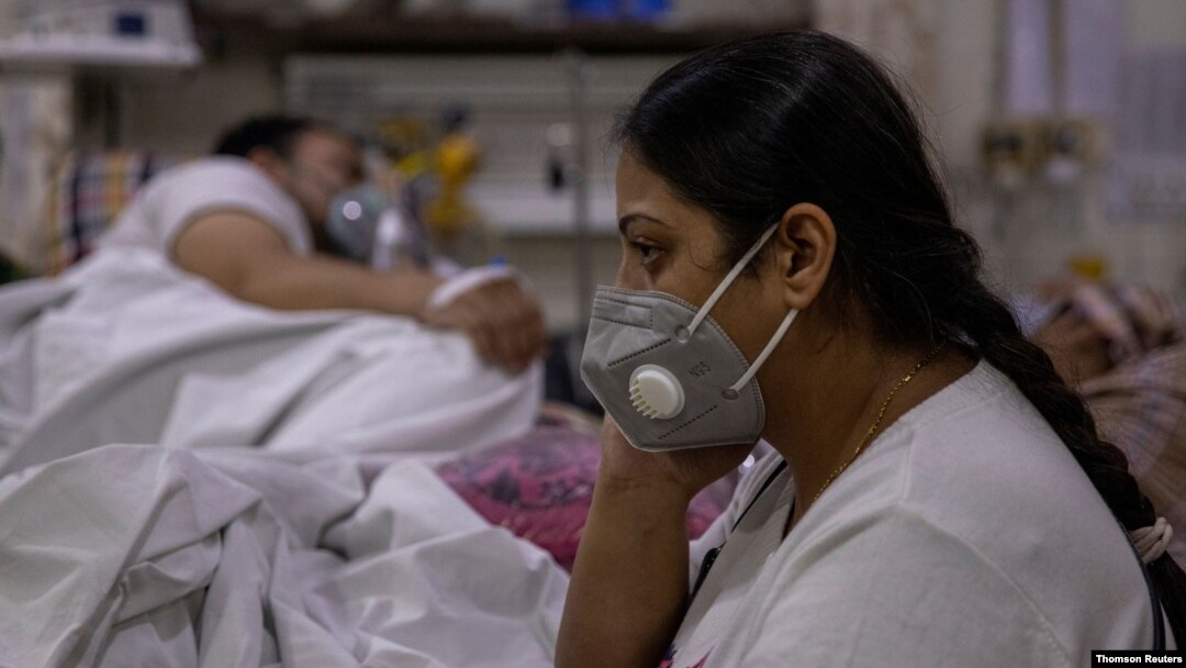 Manika Goel sits next to her husband, who has the coronavirus disease (COVID-19), inside the emergency ward at Holy Family hospital in New Delhi, India, April 29, 2021.