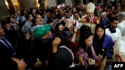 The head of the Roman Catholic Church in the Holy Land, Apostolic Administrator of the Latin Patriarchate Pierbattista Pizaballa leads the Easter Sunday procession, April 1, 2018, at the Church of the Holy Sepulchre, traditionally believed to be the site of Christ's crucifixion and resurrection, in the old city of Jerusalem. 