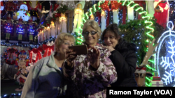 Suzanne Lechnos, center, is a regular at the holiday light display in Dyker Heights, New York.