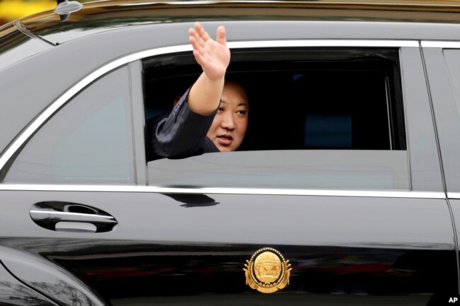 North Korean leader Kim Jong Un waves from a car after arriving by train in Dong Dang, a Vietnamese border town, Feb. 26, 2019, ahead of his second summit with U.S. President Donald Trump.