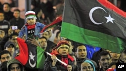 People with the Kingdom of Libya flags gather during a celebration to mark the Revolution of February 17 in Benghazi, February 16, 2012.