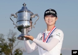 South Korea's Sung Hyun Park holds up the championship trophy after winning the U.S. Women's Open Golf tournament, July 16, 2017.
